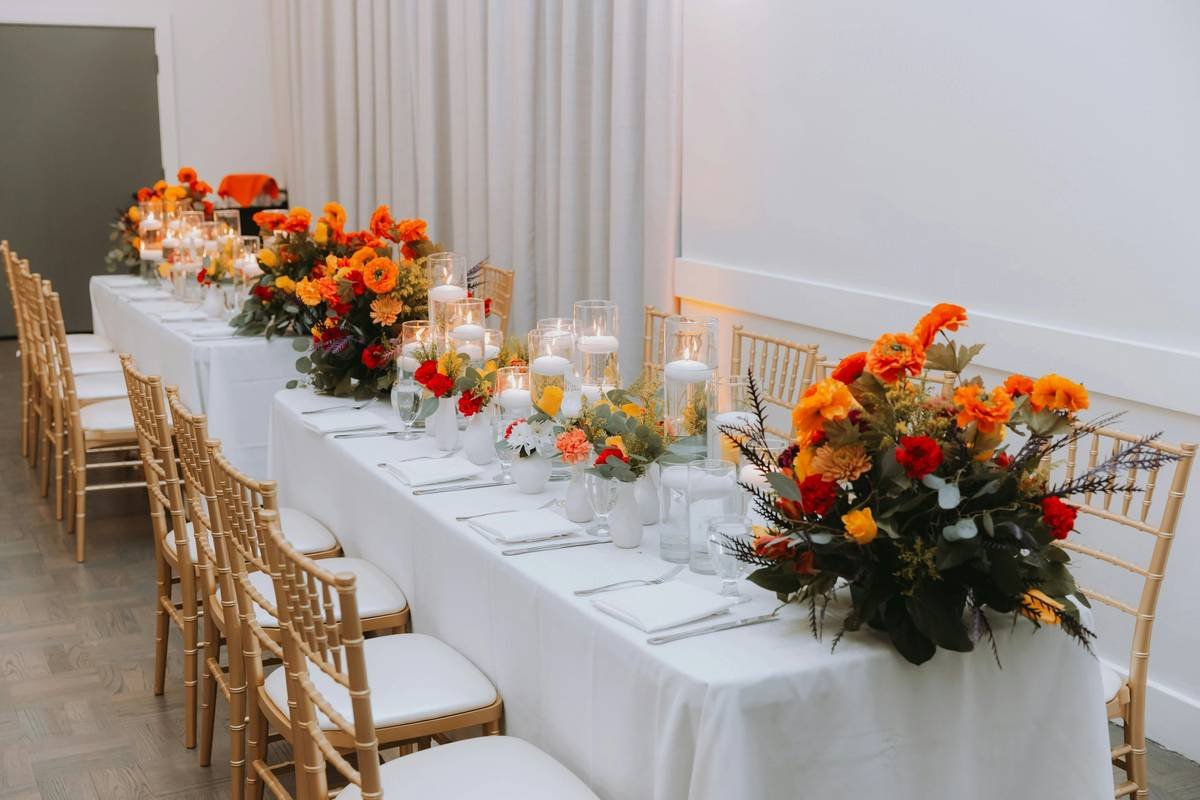 Cozy indoor decoration for anniversary party at home featuring string lights, floral centerpieces, and candlelit ambiance