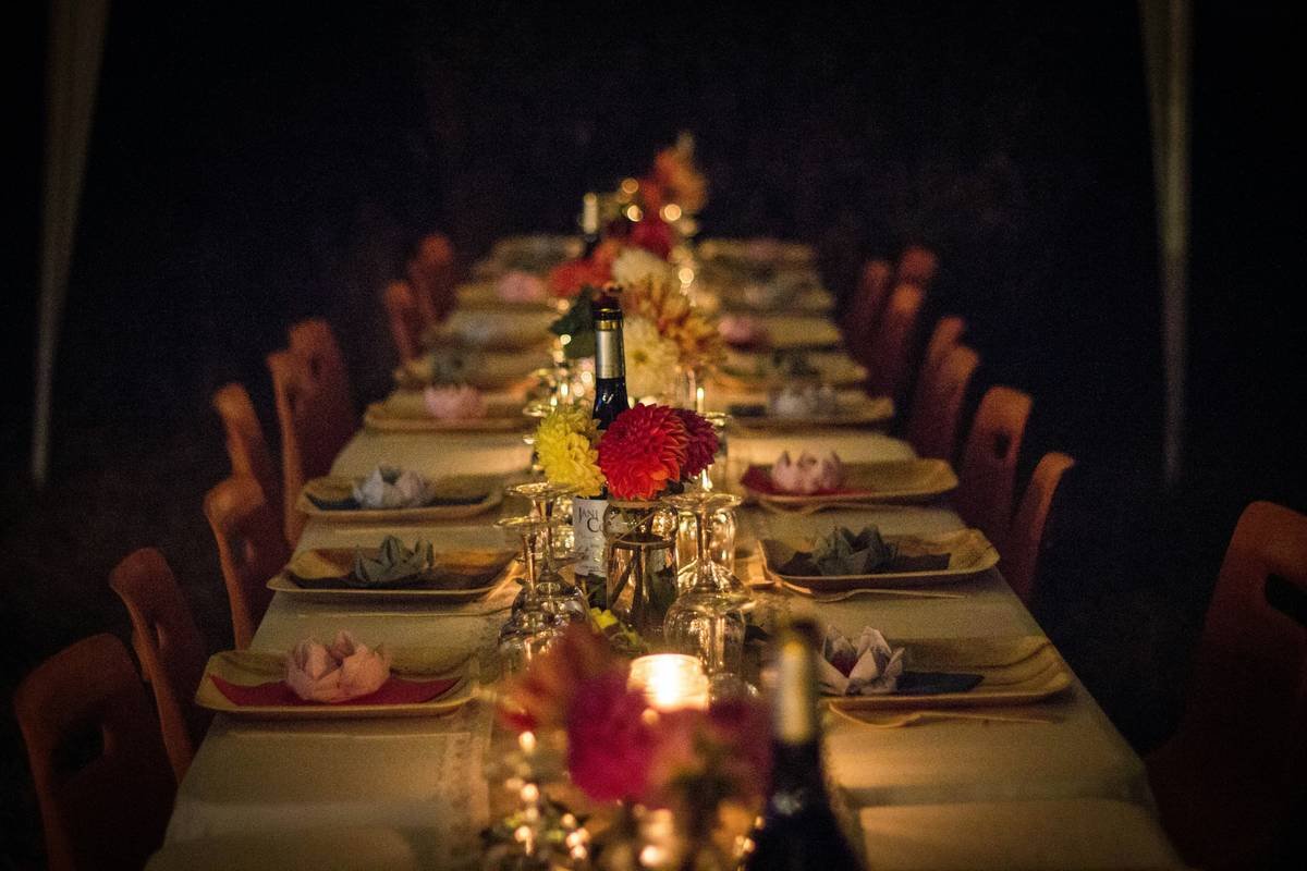 Rustic anniversary party decoration ideas with string lights and personalized photo table centerpieces